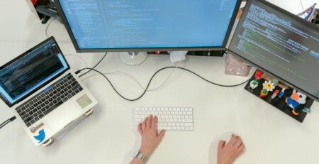 female software engineer coding on computer